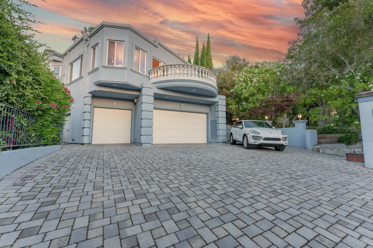 Paver motor court leading to the garage at sunset