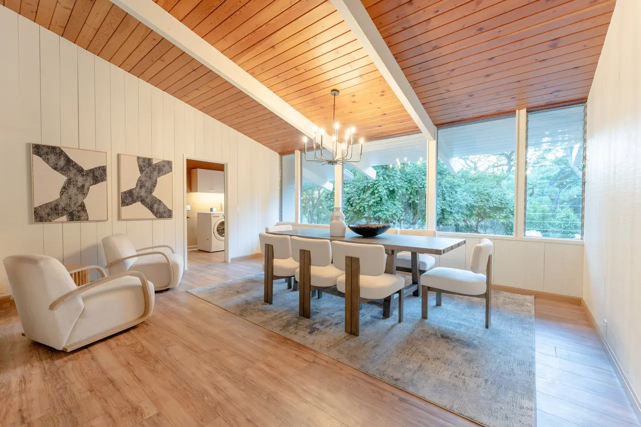 Dining room with a vaulted wood ceiling, a chandelier, and tall windows